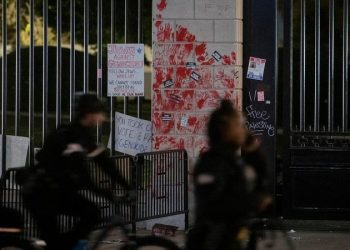 Pro-Palestinian protesters seen shaking White House gate vandalized with red paint: ‘F–k Joe Biden’