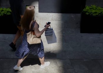 Americans are unusually down on a solid economy. So far, they aren’t spending — or voting — like it.