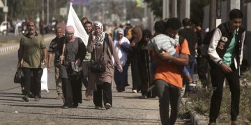 Gazans wave white flags and hold up ID papers as they flee south