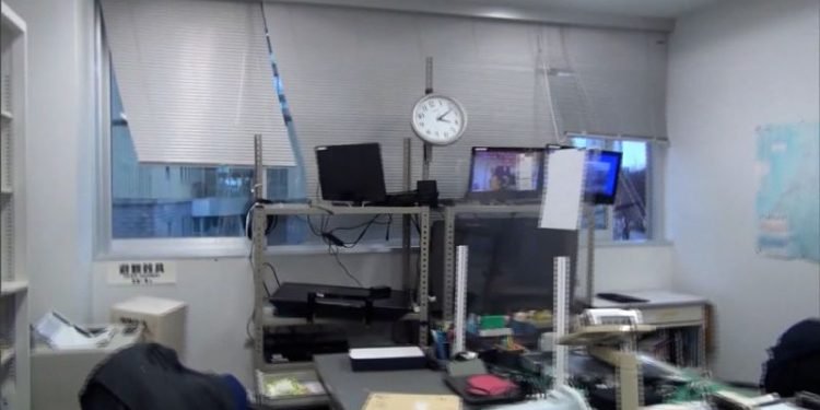 Earthquake survivors in Japan sleep in coats and hats at shelters without heat or running water