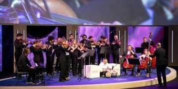 A conductor invited refugees who’d never played instruments to join his orchestra. It changed his life