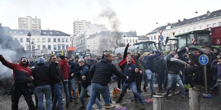 Protesting farmers hurl eggs and clog streets with tractors as EU summit begins