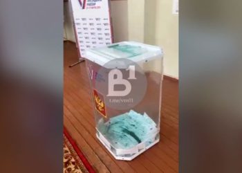 Russia opens criminal cases after protesters pour dye in ballot boxes and start fires with voting underway