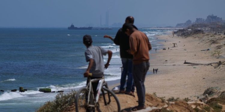US military starts delivering aid to Gaza through floating pier. Here’s what we know