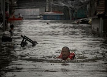 Thousands stranded by floods in Philippine capital as deadly typhoon prompts calls for climate action