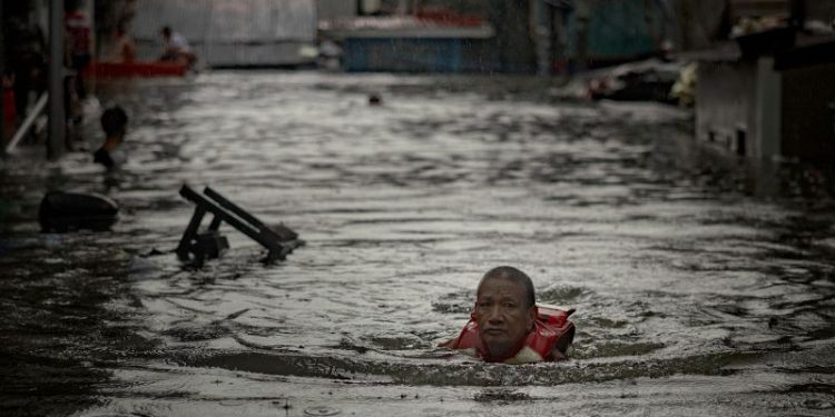 Thousands stranded by floods in Philippine capital as deadly typhoon prompts calls for climate action