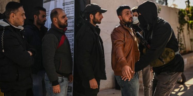 Former Assad security forces hand in weapons to new Syrian government