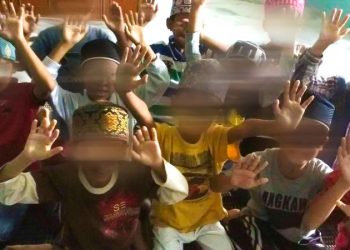 In public, they ran a successful global business. In private, police allege they abused hundreds of children