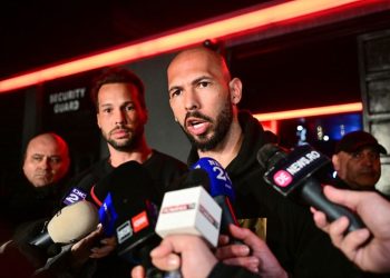 Self-proclaimed misogynist Andrew Tate and his brother appear at police station in Romania