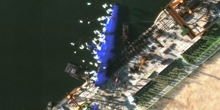 North Korea arrests four over failed warship launch as images show vessel shielded from prying eyes